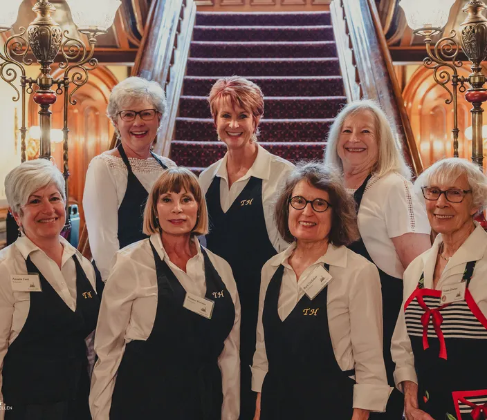 Volunteers at the base of the main staircase of Terrace Hill