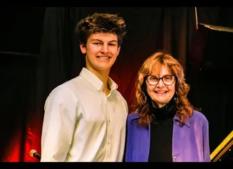 Photo of Aidan Makeeff with Steinway Café host, Jacqueline Halbloom.