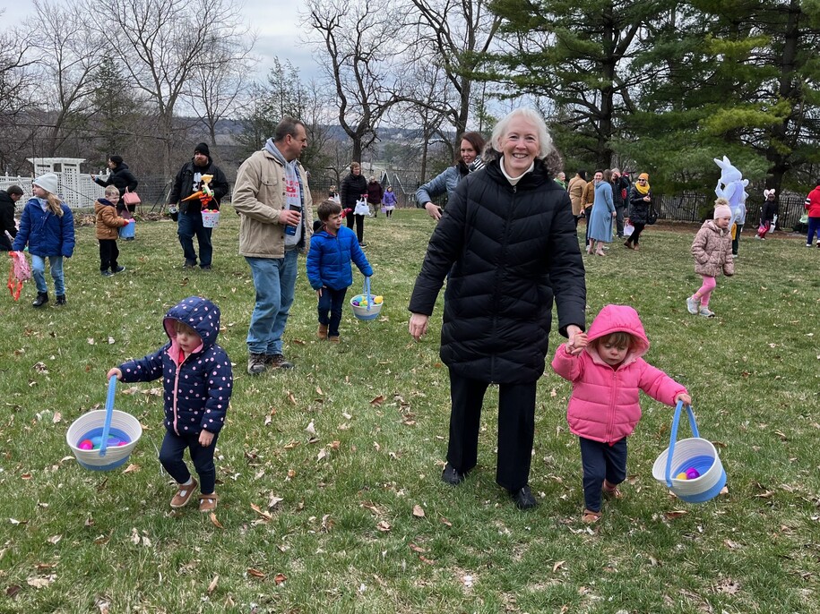 Grandmother & grandchild participating in egg hunt.